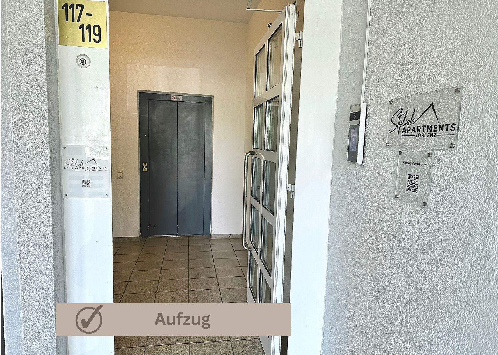 A hallway with a closed door, a sign for 'Stich Apartments Koblenz', and a QR code on the wall.