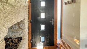 A wooden door with a frosted glass panel and a metal handle.
