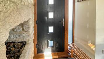 A wooden door with a frosted glass panel and a metal handle.