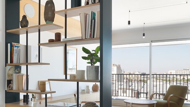 A modern living room with a large bookshelf, a dining area, and a view of the city. - Amazing view on Paris, balcony and modern apartment (Paris)