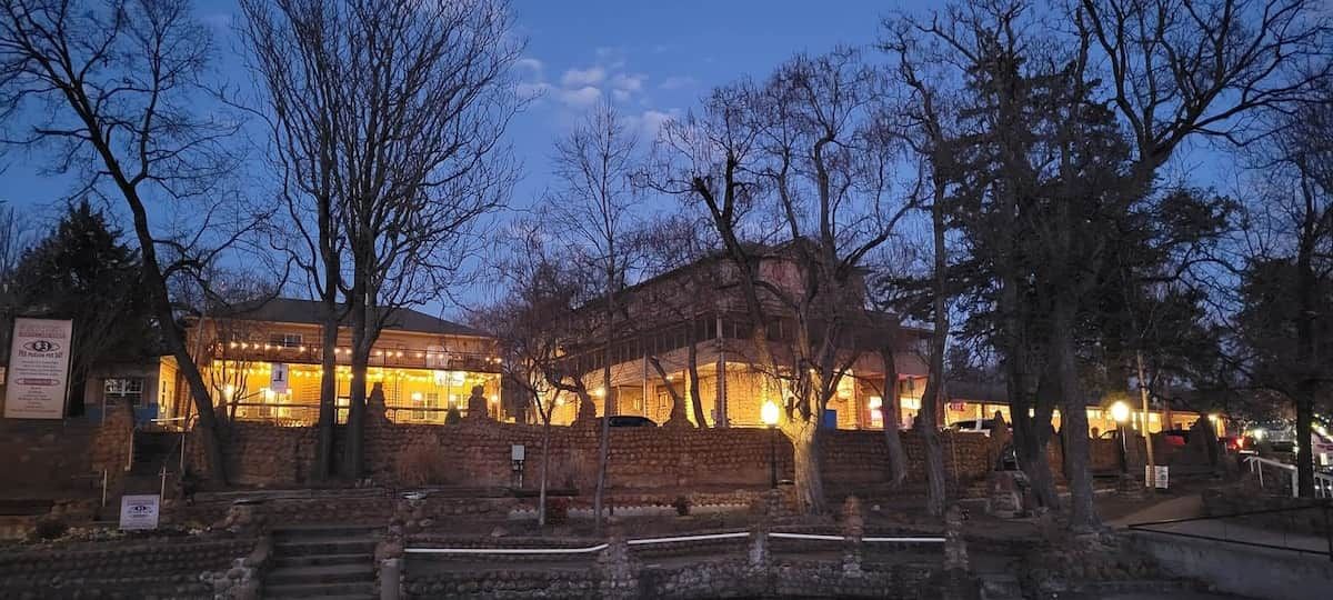 A building with multiple levels, a stone facade, and a series of steps leading to the entrance.