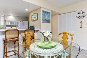 Enjoy a functional living space with a kitchenette, dining area, and comfortable seating for two.