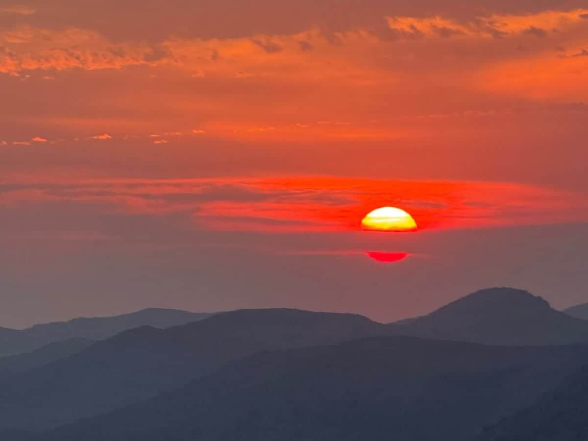 A sunset over a range of mountains.