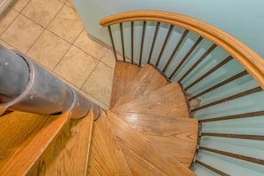 A wooden spiral staircase with metal railings.