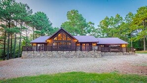 A lodge with a stone foundation, wooden exterior, and a metal roof.