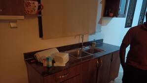 A kitchen with a sink, cabinets, and a countertop. - Cozy b n' b in Bunga (Kampala)
