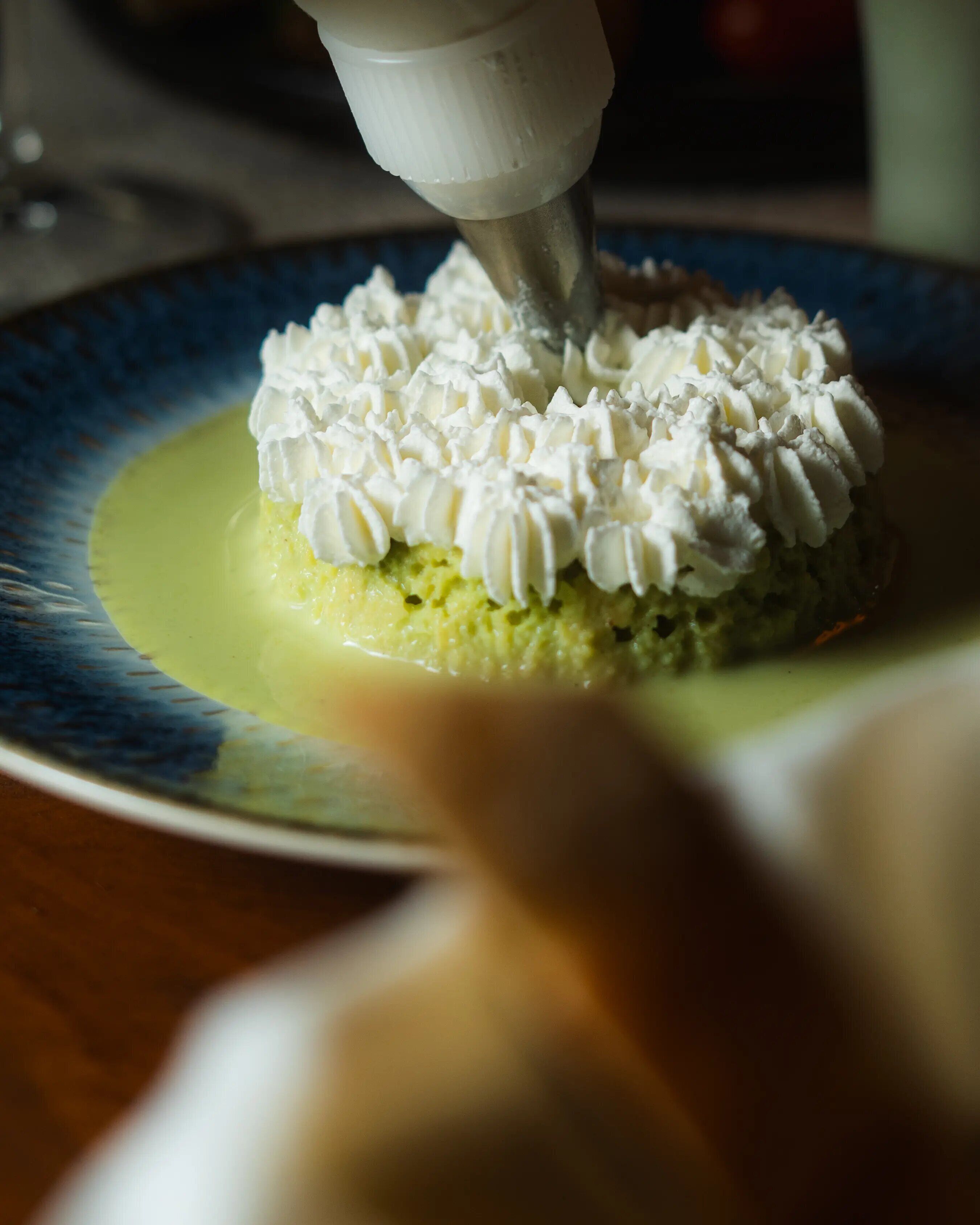 A close-up of a dessert with whipped cream on a plate.