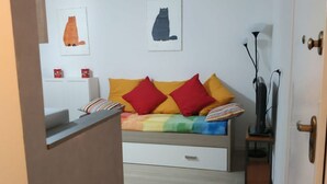 A bedroom with a bed, a nightstand, a lamp, and two wall art pieces. - Feel at Home - CASA LA POSTA (Lovere)