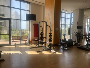 Stay active with a variety of exercise equipment, including weightlifting stations, cardio machines, and a large mirror.