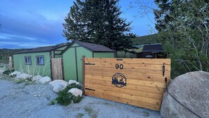 Escape to a serene mountain retreat surrounded by nature, with a cozy cabin nestled among trees.