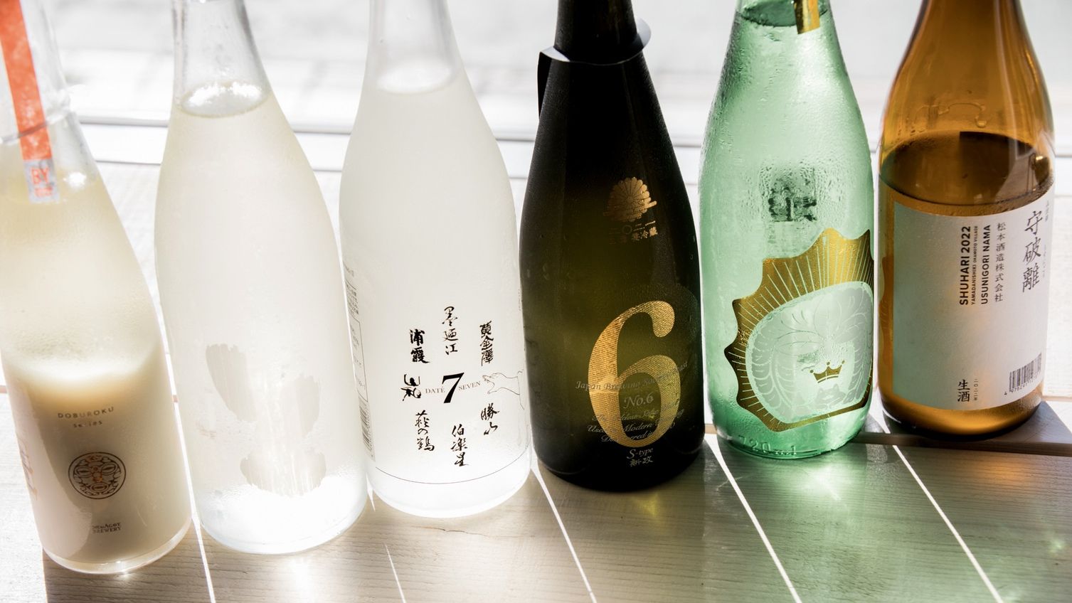 A row of bottles with labels, some with numbers and others with text.