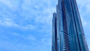 A tall, modern skyscraper with a curved design, featuring numerous windows and a glass facade.