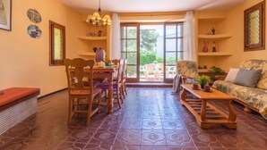 A cozy living room with a dining area, large windows, and a patterned floor. - Vacation home Moru by Interhome (Deltebre)