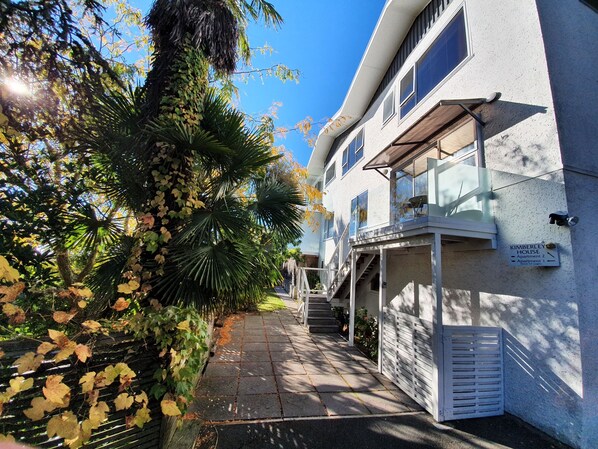 A modern building with a sign indicating 'Kimberley House' and 'Apartment 2'. - Kimberley House - 6-bedroom home in a fantastic Nelson waterfront location. (Nelson)
