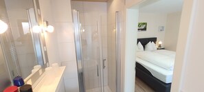Shower, rainfall showerhead, hair dryer, towels