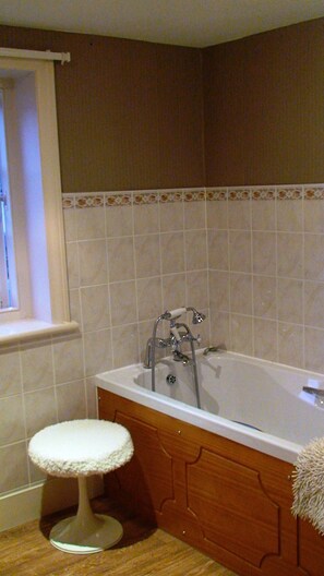 Combined shower/bathtub, towels, soap, toilet paper
