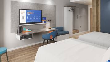 Ein modernes Hotelzimmer mit Flachbildfernseher an der Wand, einem Schreibtisch mit Stuhl, einer Couch und einem Bett.