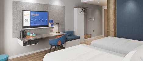 A modern hotel room with a flat-screen TV mounted on the wall, a desk with a chair, a sofa, and a bed.
