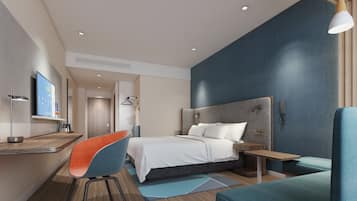 A modern hotel room with a bed, seating area, and a desk.