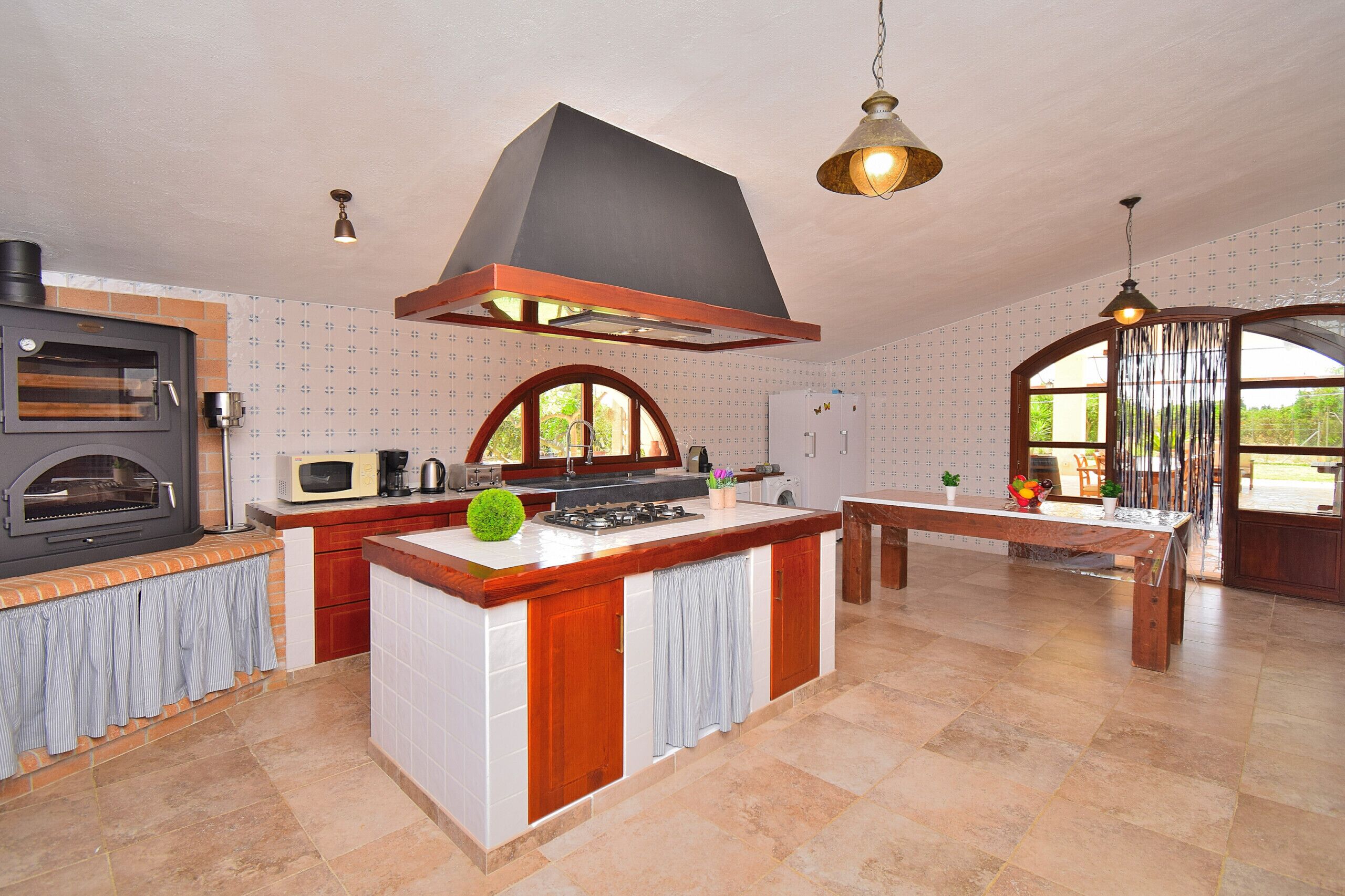 A kitchen with a built-in oven, microwave, and gas stove.