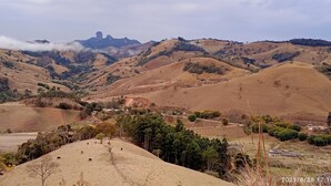 A panoramic view of rolling hills with a small settlement nestled in the valley. - Chalet in the Serra da Mantiqueira mountains in São Bento do Sapucai, near southern Minas Gerais.  (São Bento do Sapucaí)