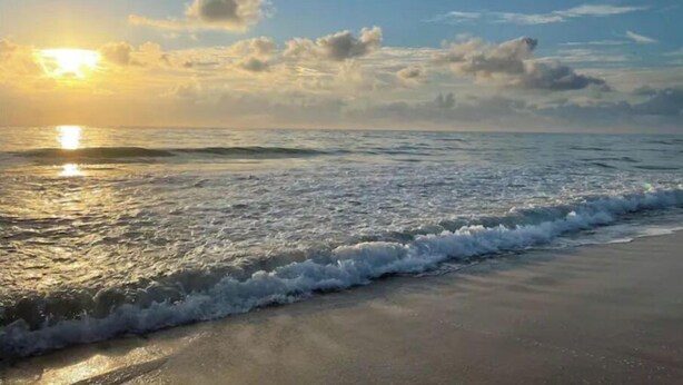 A beach with waves and a sunset. - ~ Private Beach Access! ~ East A1A ~~ Sun, Sea, Pool, Relax!  (Vero Beach)