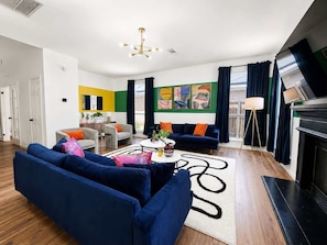 A modern living room with a fireplace, a sofa set, and a coffee table.