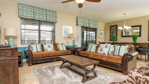 Relax in this stylish living room with a leather sofa set, wooden coffee table, and desk for work or reading.