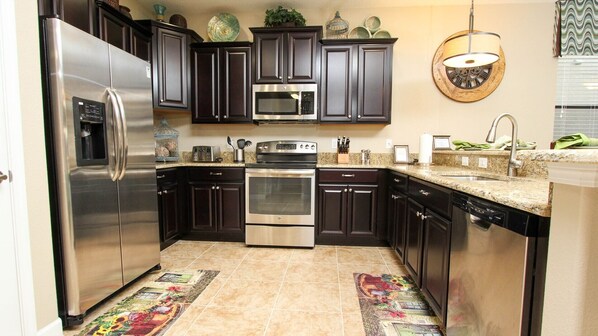 Enjoy cooking in this well-equipped kitchen with a refrigerator, microwave, oven, and dishwasher.