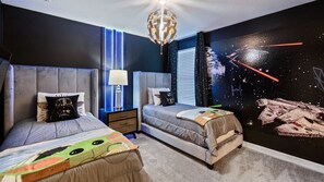 A bedroom with two beds, a nightstand, a lamp, and a Star Wars-themed wall mural. - Last Minute Disney! Private Pool, Hot Tub, Game Room & Themed Bedrooms. Book Now! #54399 (Orlando)