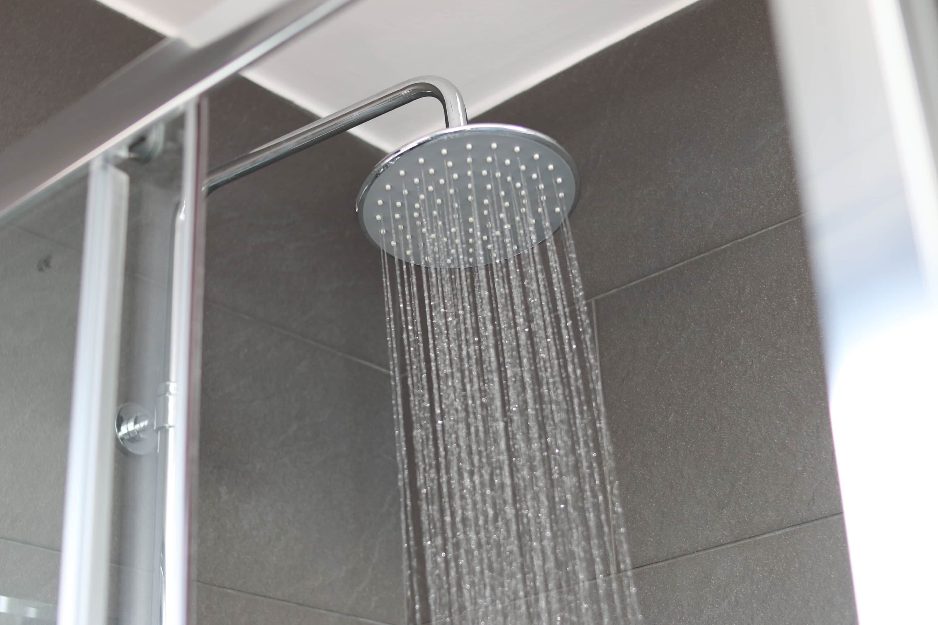 A showerhead with water flowing from it.