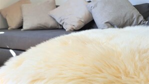 A sofa with multiple pillows in a neutral color scheme.