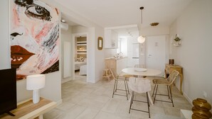 A modern interior with a dining area, a kitchen, and a living space.