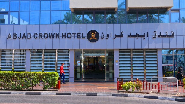 The exterior of ABJAD CROWN HOTEL with a modern glass facade and Arabic signage. - ABJAD CROWN HOTEL (Dubai)