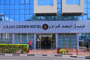 The exterior of ABJAD CROWN HOTEL with a modern glass facade and Arabic signage. - ABJAD CROWN HOTEL (Dubai)