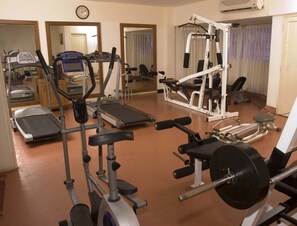A gym with treadmills, elliptical machines, and weightlifting equipment. - THE SOUTH PARK (Thiruvananthapuram)