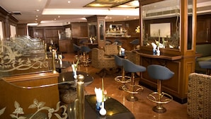 A luxurious hotel lobby with ornate furniture, a bar area, and a decorative ceiling. - THE SOUTH PARK (Thiruvananthapuram)