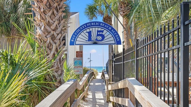 A wooden boardwalk leading to a beach with a sign reading "Bay County Public Beach Access". - Beach House - Gulf Dream (Panama City Beach)