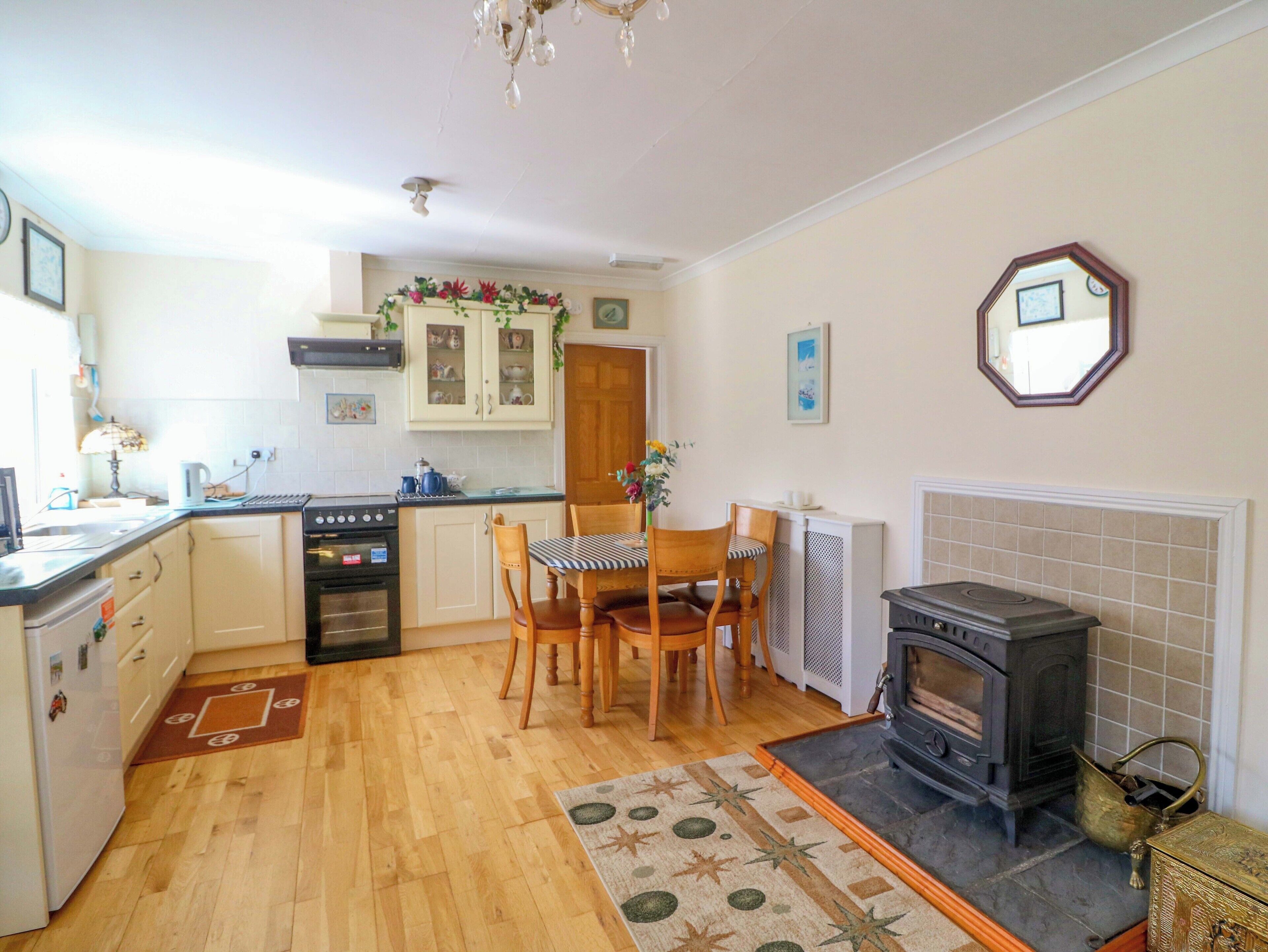 A compact kitchen with a stove, oven, and dining area.