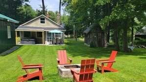 A backyard with a hot tub, a covered patio, and a wooden shed. - 3 bedroom home steps away from beach/lake (Petersburg)
