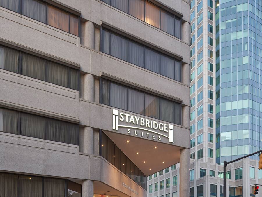 A Staybridge Suites hotel with a modern facade, large windows, and a prominent entrance.