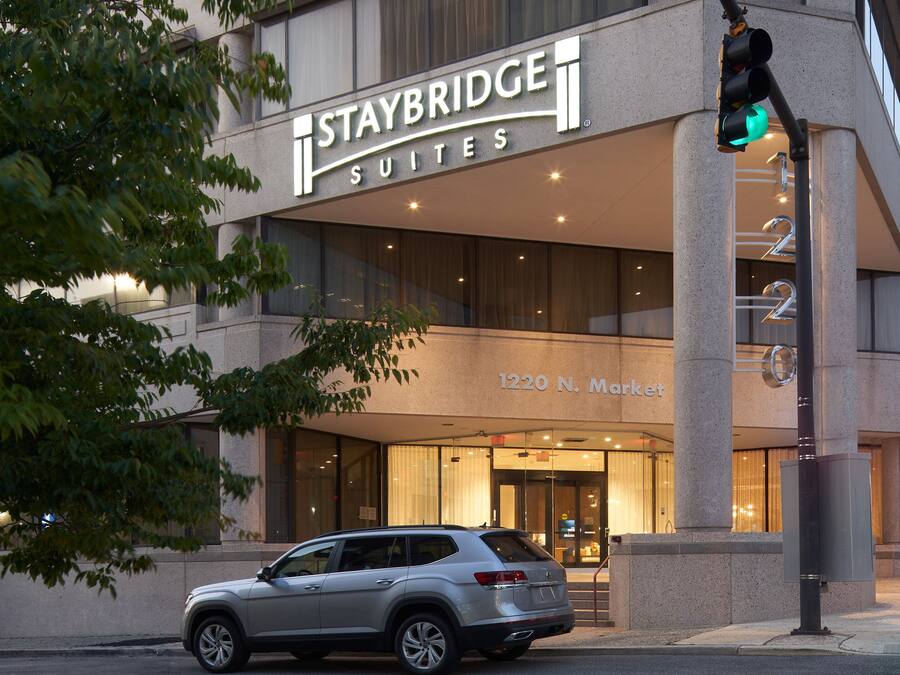 A Staybridge Suites hotel with a modern facade, large windows, and a visible entrance.