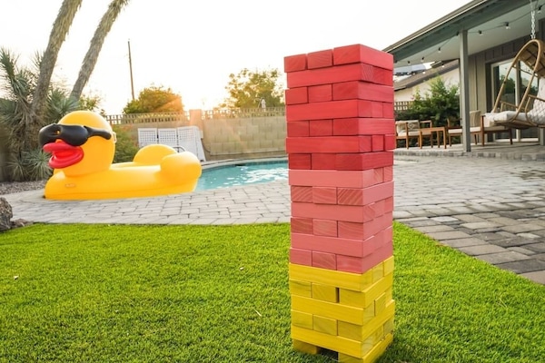 You and your guests can enjoy the sunny outdoors in this backyard designed to bring good vibes!