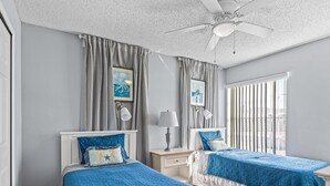 A hotel room with two beds, a ceiling fan, and large windows. - Pool, Spa, Playground and More at Villas at Laguna Bay!! (Kissimmee)