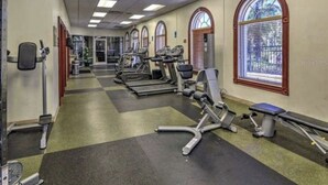 A gym with treadmills, elliptical machines, and weight benches. - 3 bedroom villa (Sleeps 8) in a tropical Tuscan style resort near Disney (Davenport)