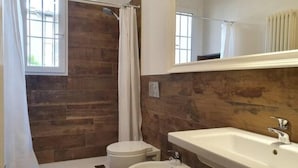 A bathroom with a wooden wall, a shower curtain, a toilet, a bidet, and a sink. - Zanobi 66 - Two Bedroom Apartment, Sleeps 4 (Firenze)