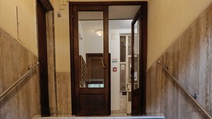 A marble staircase leading to a door with a metal handrail on both sides. - Regina House in the center of Cagliari (Cagliari)