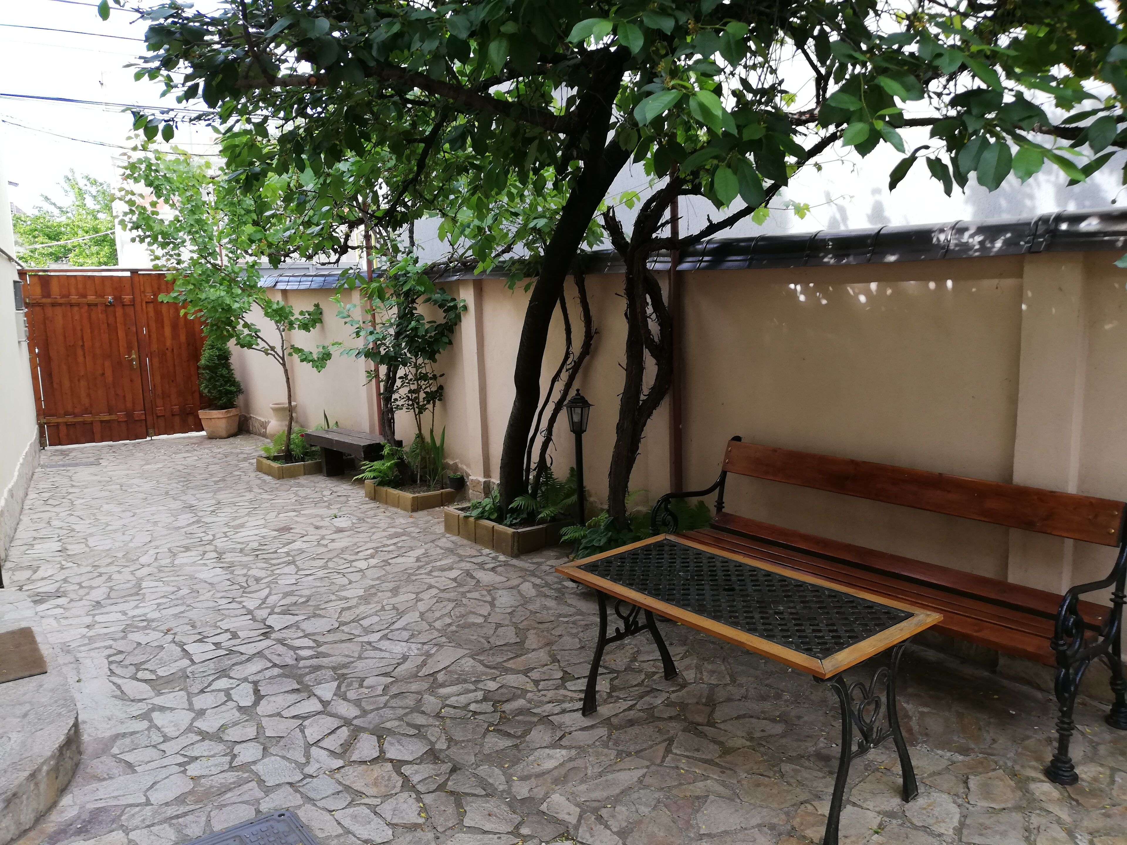 View of the table and the bench in the patio of the guest house
