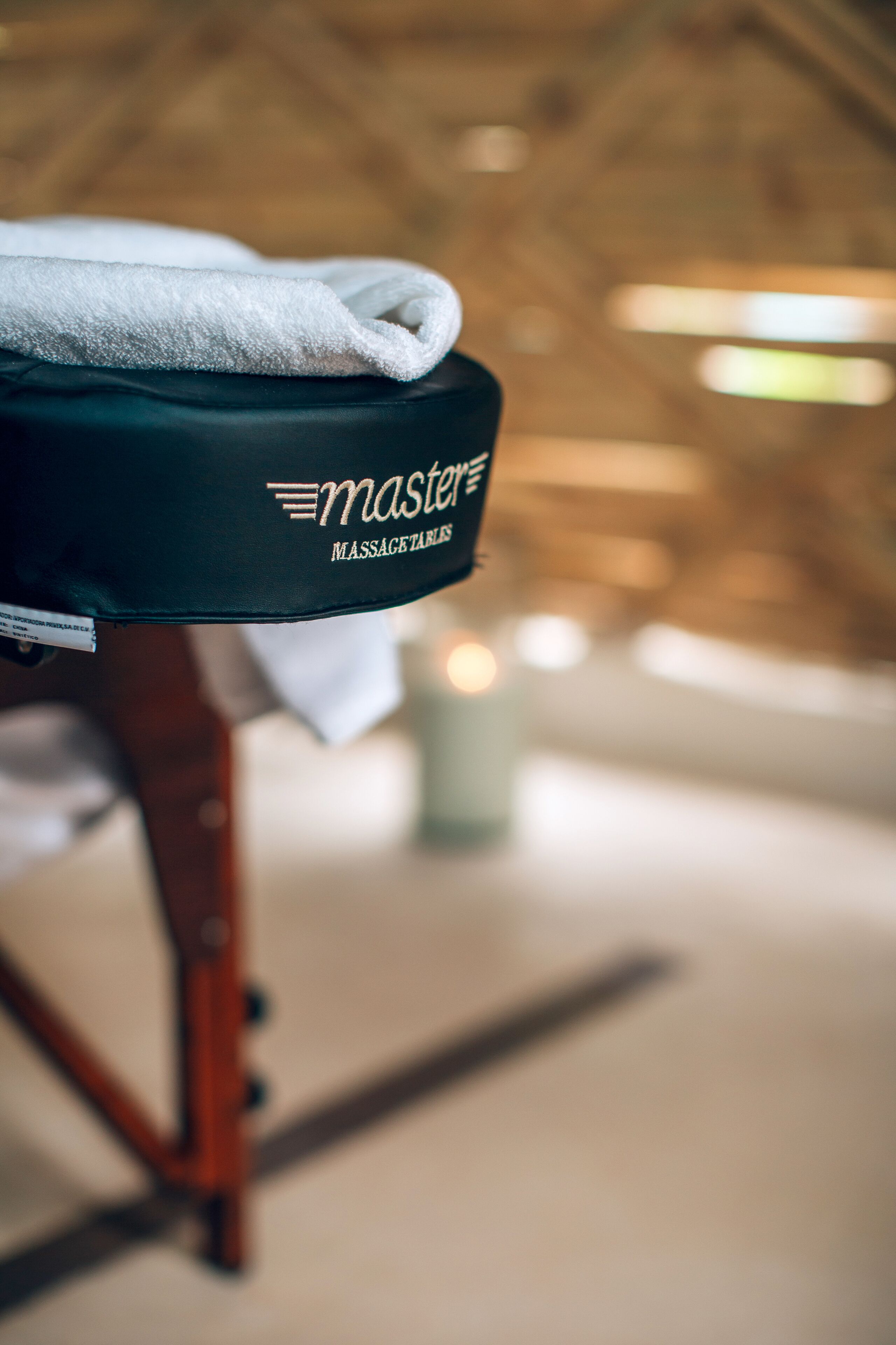 A massage chair with a towel and a sign that reads "Master Massage."