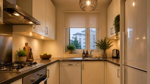 A modern kitchen with a gas stove, oven, dishwasher, and a window with a view of buildings. - A MILLION DOLLAR VIEW IN THE HEART OF ISTANBUL (İstanbul)